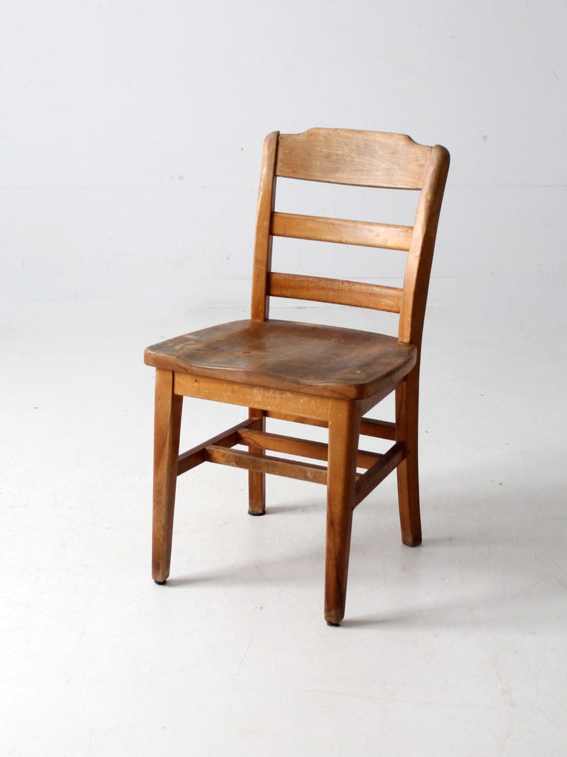 Vintage Wisconsin Wooden Desk Chair Ladder Back Saddle Seat: Vintage Wisconsin Wooden Desk Chair Ladder Back Saddle Seat This vintage wooden desk chair from the University of Wisconsin combines classic design with practical features. It showcases a traditional 