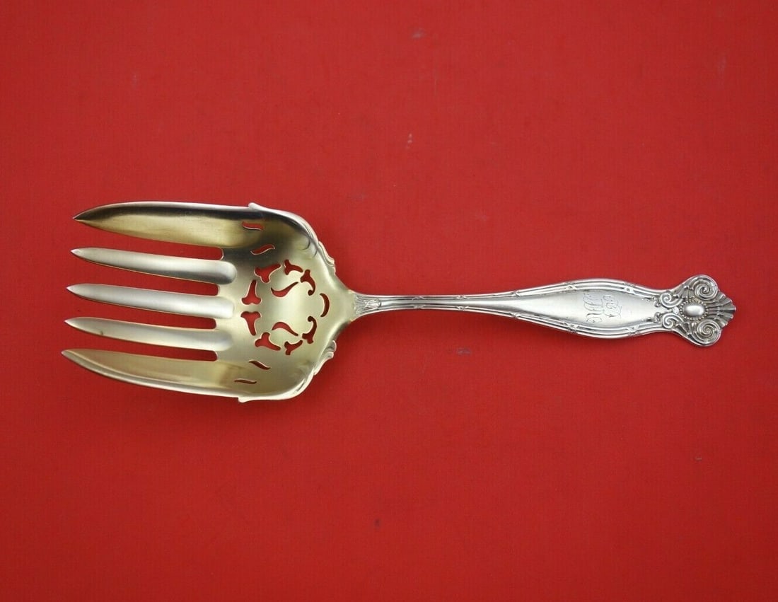 Towle Empire Sterling Silver Gold Washed Pierced Serving Fork 8 7/8": Towle Empire Sterling Silver Gold Washed Pierced Serving Fork 8 7/8" This exquisite serving fork is part of the Empire pattern by Towle, crafted from sterling silver with a luxurious gold wash finish.