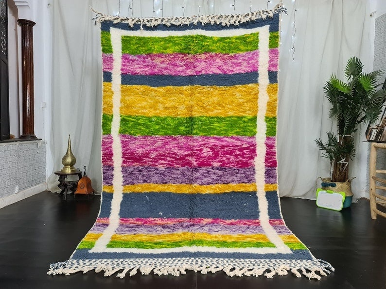 Handmade Moroccan Berber Wool Rug 10 x 5 Feet Colorful Design: Handmade Moroccan Berber Wool Rug 10 x 5 Feet Colorful Design This stunning handmade Moroccan Berber wool rug features a vibrant array of colors, including bright pink, yellow, and green, framed elega
