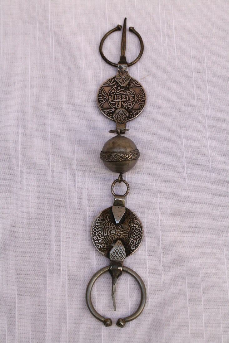 19th Century Rare Islamic Silver Prayer with Coins 1320 1321: 19th Century Rare Islamic Silver Prayer with Coins 1320 1321 This exquisite 19th-century Islamic silver prayer piece showcases the intricate craftsmanship of Moroccan artisans. Made from a silver allo