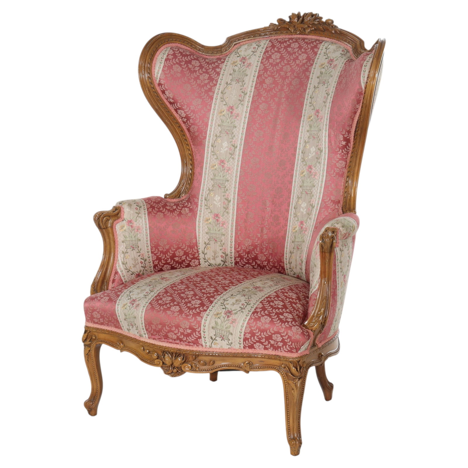 English Walnut Wingback Lolling Chair c1920 Oversized: English Walnut Wingback Lolling Chair c1920 Oversized This oversized English carved walnut wingback lolling chair dates to circa 1920 and is crafted in the Rococo Revival style. The chair features an 