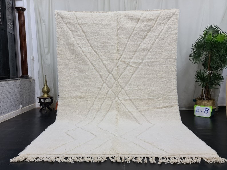 Authentic Handmade Moroccan Berber Rug 9.84 x 6.56 Feet: Authentic Handmade Moroccan Berber Rug 9.84 x 6.56 Feet Discover the beauty of this stunning authentic soft white handmade Moroccan Berber rug, featuring an engraved geometric pattern. Crafted by skil