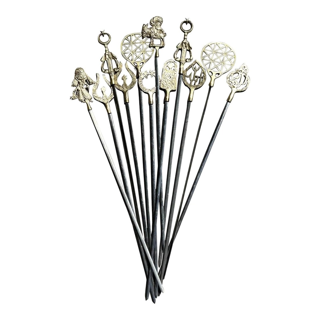 Set of 12 Vintage Boho Brass Icon Skewers with Unique Figures: Set of 12 Vintage Boho Brass Icon Skewers with Unique Figures Enhance your serveware collection with this captivating set of 12 vintage brass character skewers. Each skewer features a uniquely crafted