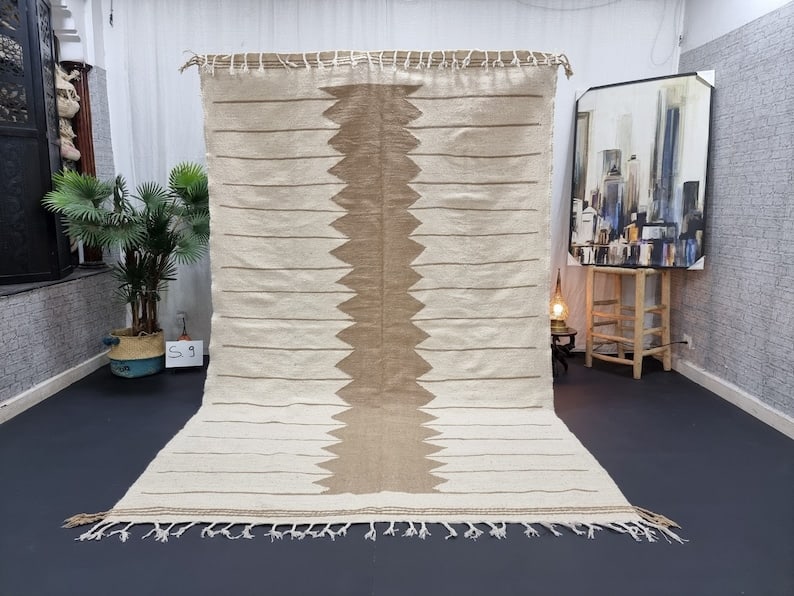 Authentic Handwoven Berber Wool Rug 9.84 x 6.56 ft Morocco: Authentic Handwoven Berber Wool Rug 9.84 x 6.56 ft Morocco Experience the elegance of this stunning handmade beige rug, an authentic piece crafted by local Berber women weavers in the Atlas Mountains 