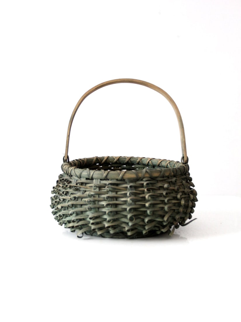 Mid Century Handwoven Porcupine Basket with Bail Handle: Mid Century Handwoven Porcupine Basket with Bail Handle This mid-century folk art basket showcases a handwoven curl weave design with a bentwood bail handle. The intricate looped reed weaving forms a 