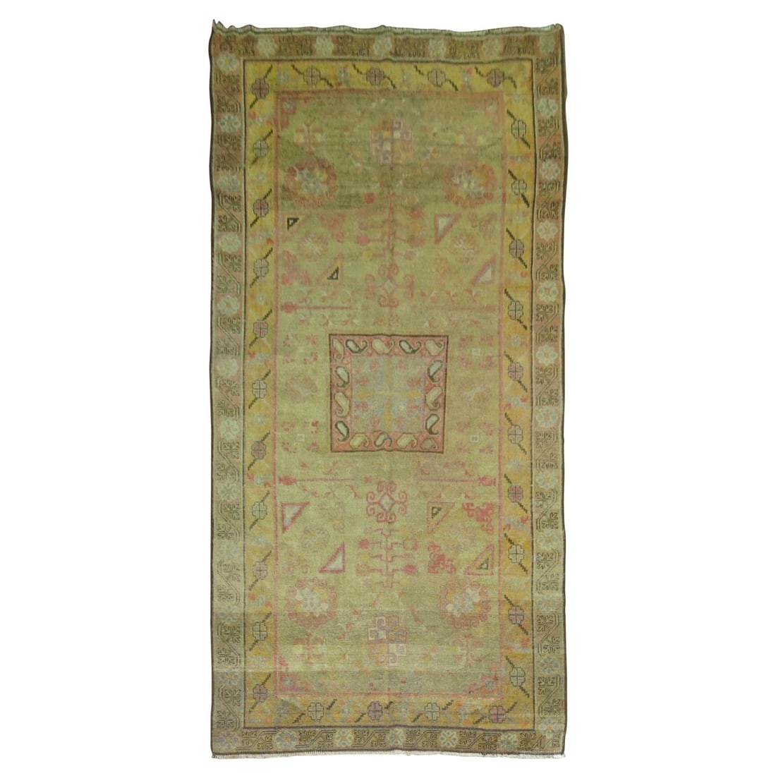 Late 19th Century East Turkestan Wool Khotan Rug 5'2 x 10'8: Late 19th Century East Turkestan Wool Khotan Rug 5'2 x 10'8 This antique Khotan rug from the late 19th century features a soft green field with intricate hand-knotted designs. Originating from East Tu