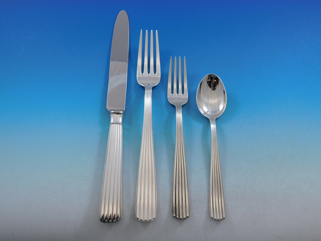 Fina America Sterling Silver 4-Piece Dinner Place Setting: Fina America Sterling Silver 4-Piece Dinner Place Setting Enhance your dining experience with this exquisite 4-piece place setting in the 'America' pattern by Fina, crafted from sterling silver. This 