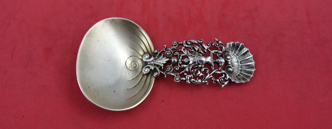 Gorham Sterling Silver Confection Spoon 450 Mermaid Design 4 3/4": Gorham Sterling Silver Confection Spoon 450 Mermaid Design 4 3/4" This exquisite serving spoon from Gorham showcases a charming mermaid and seashell motif, crafted in high-quality sterling silver. Mea
