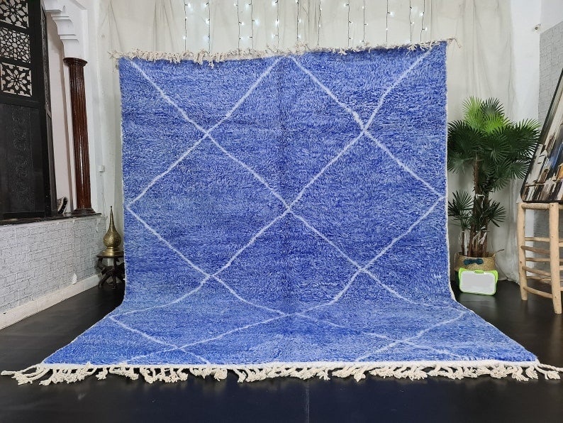Handmade Blue Wool Rug with Geometric Design from Morocco: Handmade Blue Wool Rug with Geometric Design from Morocco Experience the elegance of this stunning soft blue handmade wool rug, featuring a captivating geometric white design. This piece is meticulous