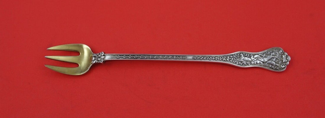 Tiffany & Co Olympian Sterling Silver 3-Tine Oyster Fork Gold Wash 6 1/8": Tiffany & Co Olympian Sterling Silver 3-Tine Oyster Fork Gold Wash 6 1/8" This exquisite oyster fork from the Olympian pattern by Tiffany & Co. showcases a classic design in sterling silver with a gol