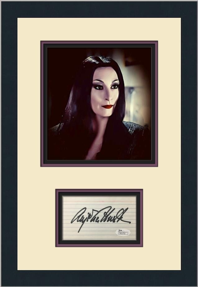 Angelica Huston Signed The Addams Family Framed Photo JSA Authenticated: Angelica Huston Signed The Addams Family Framed Photo JSA Authenticated This elegant piece features a signed index card by Angelica Huston, renowned for her role in the classic film 'The Addams Family