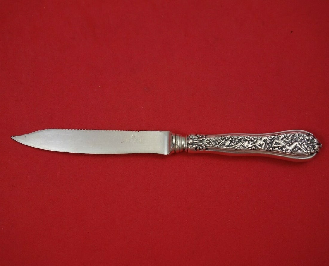 Tiffany & Co Olympian Sterling Silver 7 Inch Fruit Knife: Tiffany & Co Olympian Sterling Silver 7 Inch Fruit Knife This exquisite fruit knife features a hollow handle crafted from sterling silver, complemented by a silverplate serrated blade. Measuring 7 inc