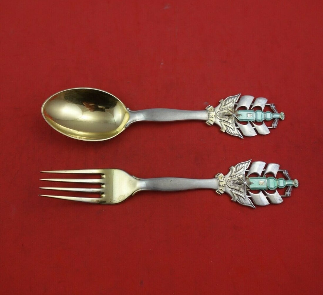 A. Michelsen Christmas Vermeil Fork and Spoon Set 2pc 1930: A. Michelsen Christmas Vermeil Fork and Spoon Set 2pc 1930 This exquisite 2-piece fork and spoon set, crafted by A. Michelsen, features a charming Christmas pattern designed by Arne Bang. Made from st
