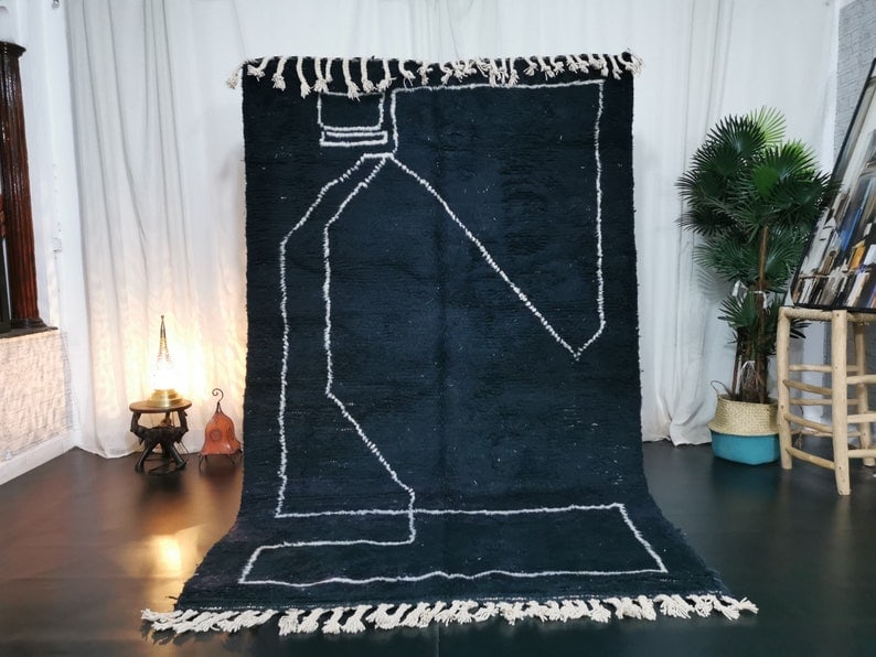 Stunning Black Moroccan Berber Wool Rug 9.84 x 6.56 Feet: Stunning Black Moroccan Berber Wool Rug 9.84 x 6.56 Feet Experience the elegance of this stunning black handmade Moroccan Berber wool rug. Featuring a captivating white pattern, this rug adds a unique