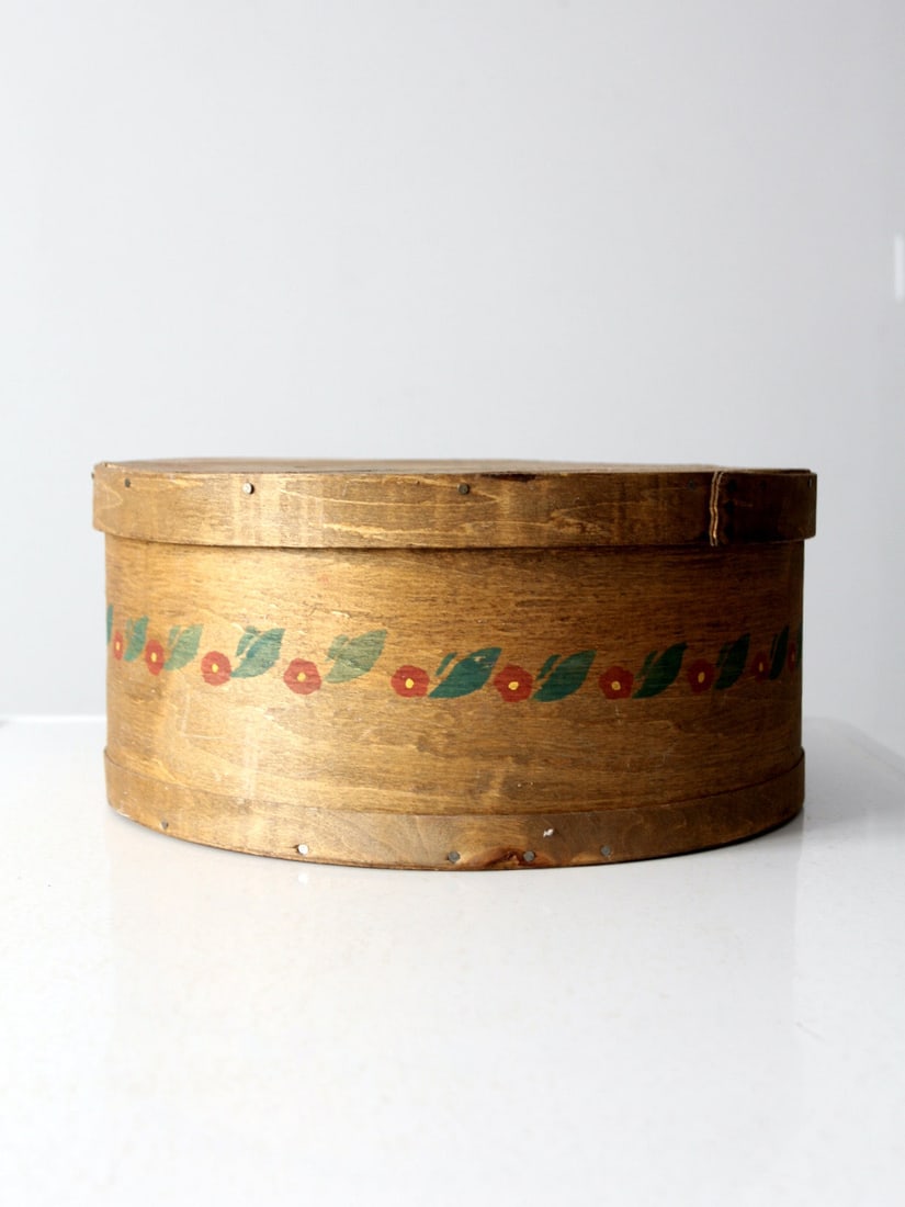 Seymour Woodenware Co Painted Pineapple Floral Cheese Box: Seymour Woodenware Co Painted Pineapple Floral Cheese Box This early 20th century cheese box was crafted by the Seymour Woodenware Co. of Wisconsin. Featuring bentwood sides in a warm honey tone, it i