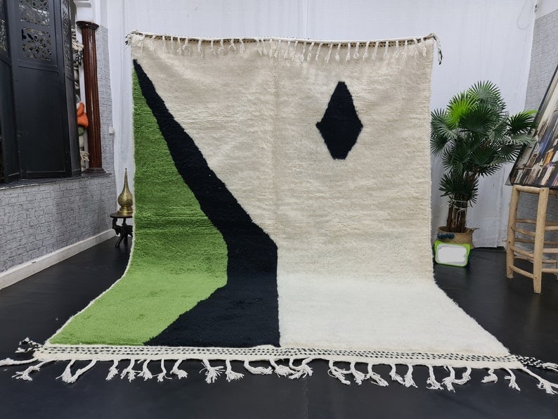 Handmade Moroccan Berber Wool Rug 9.84 x 6.56 Feet: Handmade Moroccan Berber Wool Rug 9.84 x 6.56 Feet Experience the charm of Moroccan craftsmanship with this Elegant Soft Handmade Moroccan Berber Wool Rug. Featuring a beautiful blend of three main co