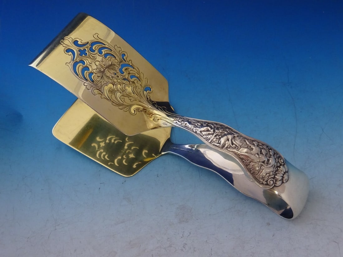 Tiffany & Co Olympian Sterling Silver Asparagus Serving Tong Gold Washed 7.5": Tiffany & Co Olympian Sterling Silver Asparagus Serving Tong Gold Washed 7.5" Enhance your dining experience with the Olympian by Tiffany & Co. Sterling Silver Asparagus Serving Tong. Crafted from hig
