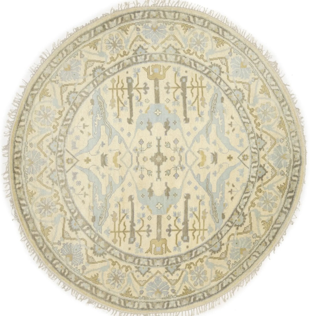 Round hand knotted wool Oushak floral area rug 8x8: Round hand knotted wool Oushak floral area rug 8x8 This hand-knotted Oushak round rug features a transitional floral pattern in muted tones of cream, brown, light blue, and golden beige. Crafted from 
