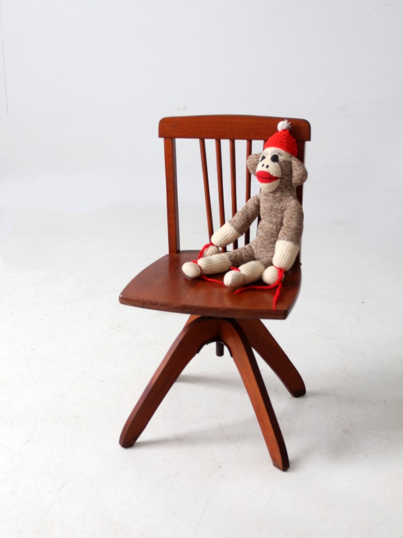 Mid-Century Wooden Kids Swivel Chair with Spindle Back: Mid-Century Wooden Kids Swivel Chair with Spindle Back This charming mid-century wooden kids swivel chair features a spindle back and a sculpted base, showcasing a compact design with balanced proport