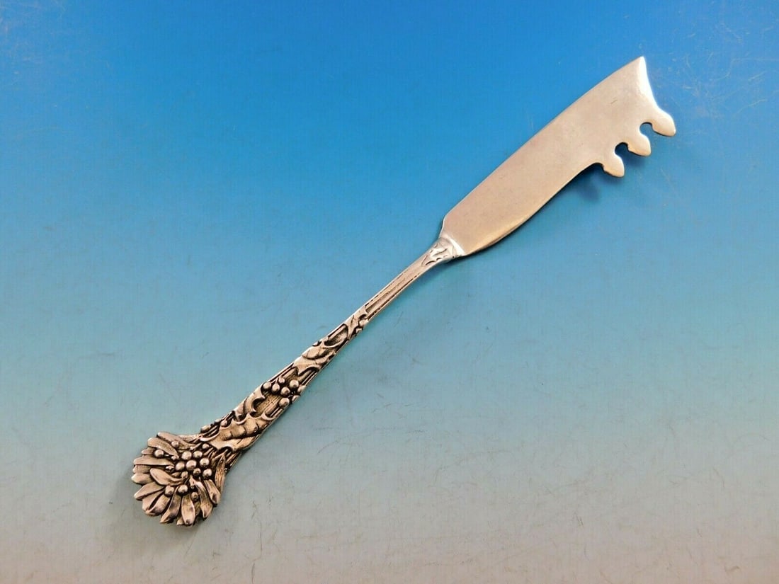 Tiffany & Co. Holly Sterling Silver Cheese Knife with Pick 7 1/4": Tiffany & Co. Holly Sterling Silver Cheese Knife with Pick 7 1/4" Elevate your dining experience with the Holly by Tiffany & Co. sterling silver cheese knife, a stunning piece from the 1850-1899 era. 