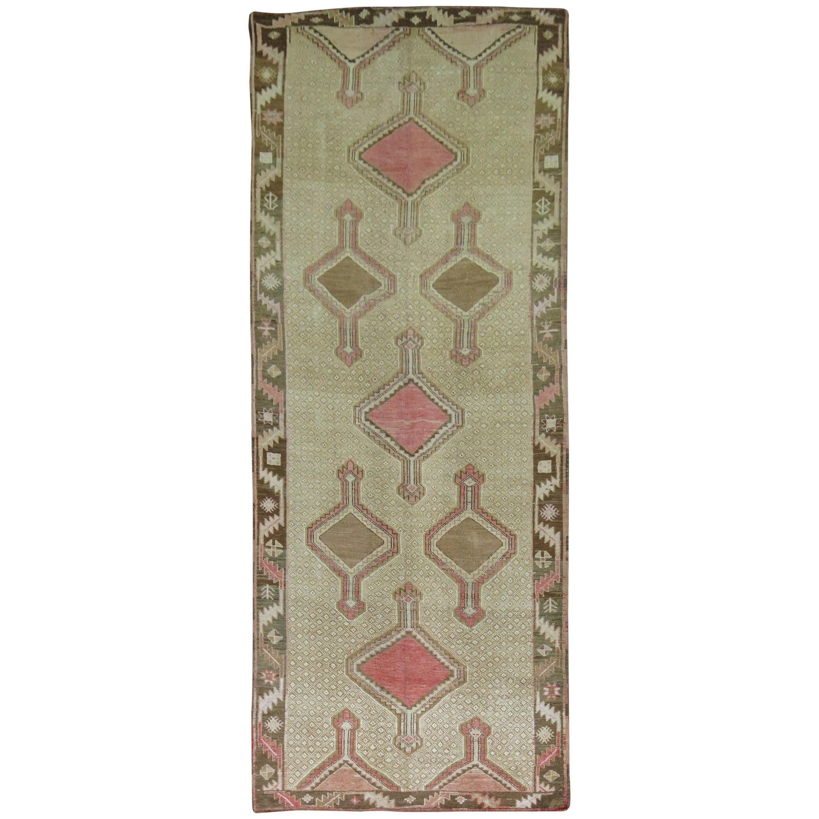 4'7" x 12'5" Wool Turkish Tribal Gallery Rug with Pink Accents Circa 1940: 4'7" x 12'5" Wool Turkish Tribal Gallery Rug with Pink Accents Circa 1940 This vintage Turkish gallery rug from the mid-20th century features a tribal design with pink and brown medallions on a khaki 