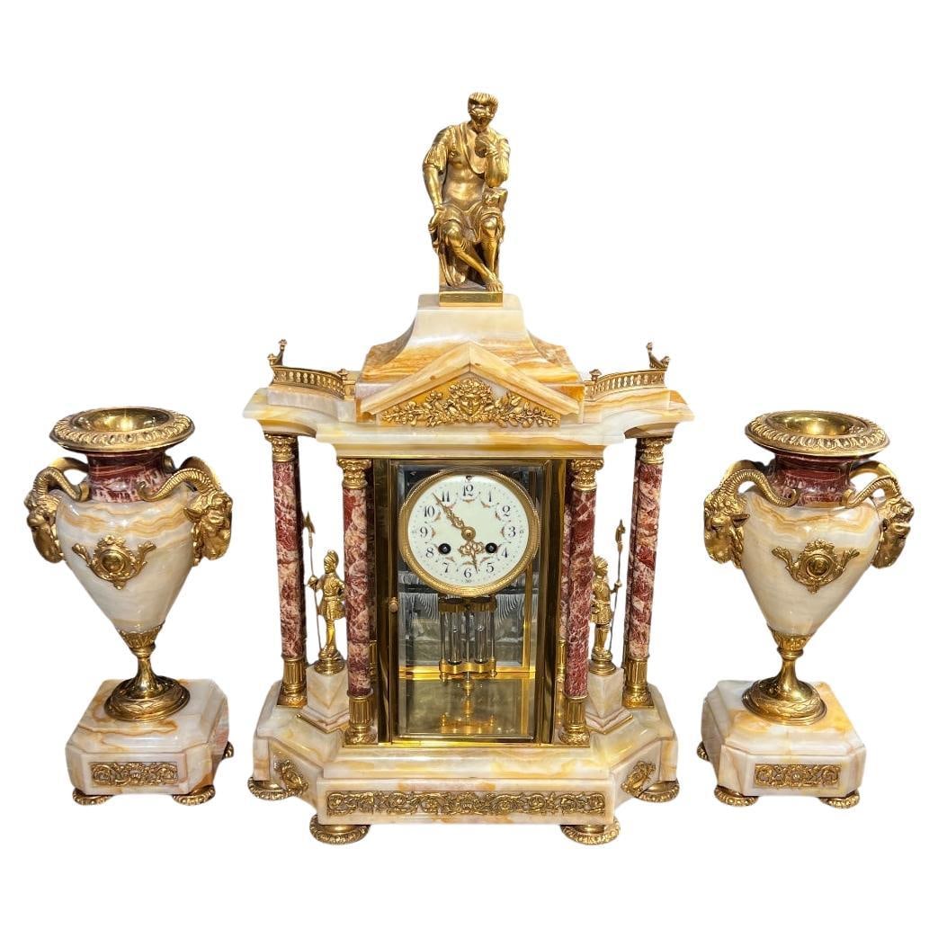 French Neoclassical Onyx and Gilt Brass Garniture Clock Set with Vases Circa 1900: French Neoclassical Onyx and Gilt Brass Garniture Clock Set with Vases Circa 1900 This antique French garniture set from the late 19th century features a neoclassical portico style mantel clock and a 