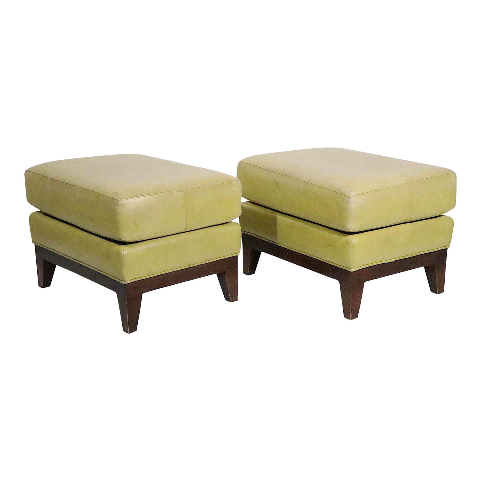 Vintage Pair of Leather Ottomans on Solid Wood Base 1970s: Vintage Pair of Leather Ottomans on Solid Wood Base 1970s This stylish pair of matching leather poufs doubles as stools or ottomans, offering both comfort and functionality. Each piece features thick 