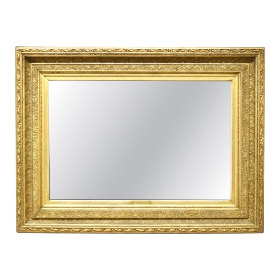 c1890 Fern Motif Giltwood Rectangular Wall Mirror 30.25H x 41W: c1890 Fern Motif Giltwood Rectangular Wall Mirror 30.25H x 41W Antique late 19th-century wall mirror with a rectangular giltwood frame and a richly detailed fern motif. The frame features intricate ca