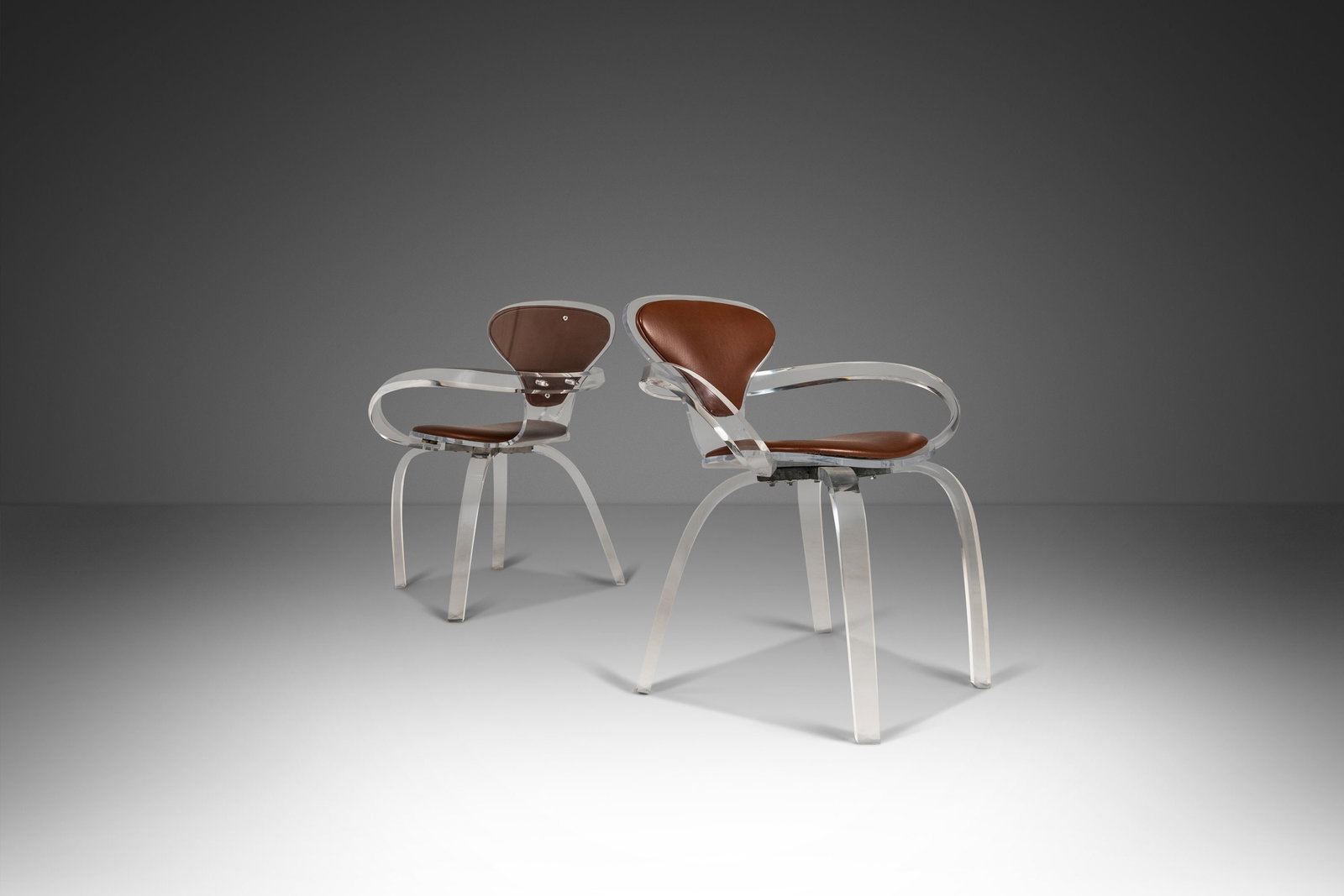 Set of 2 Lucite Pretzel Armchairs After Norman Cherner 1980s USA: Set of 2 Lucite Pretzel Armchairs After Norman Cherner 1980s USA This extraordinary set of two designer Lucite decorative pretzel armchairs, inspired by the iconic designs of Norman Cherner, boasts a 