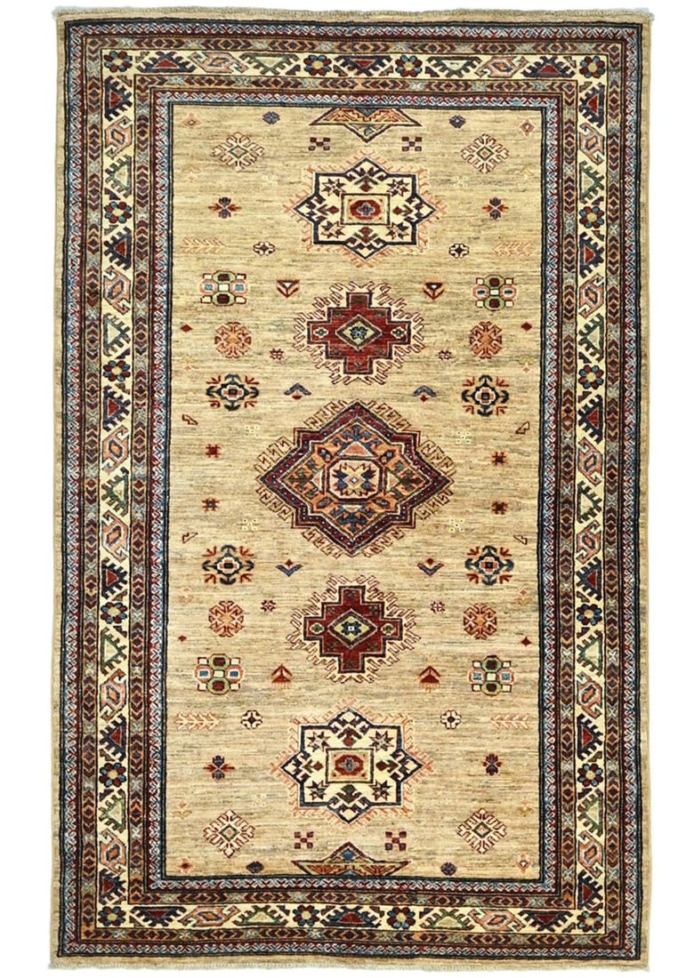 Hand-Knotted Wool Kazak Rug 3'11 x 6'3 Tribal Geometric Pattern: Hand-Knotted Wool Kazak Rug 3'11 x 6'3 Tribal Geometric Pattern This handmade Kazak area rug features a tribal geometric design in a mix of rust, cream, pastel yellow, dark brown, and blue-gray tones.