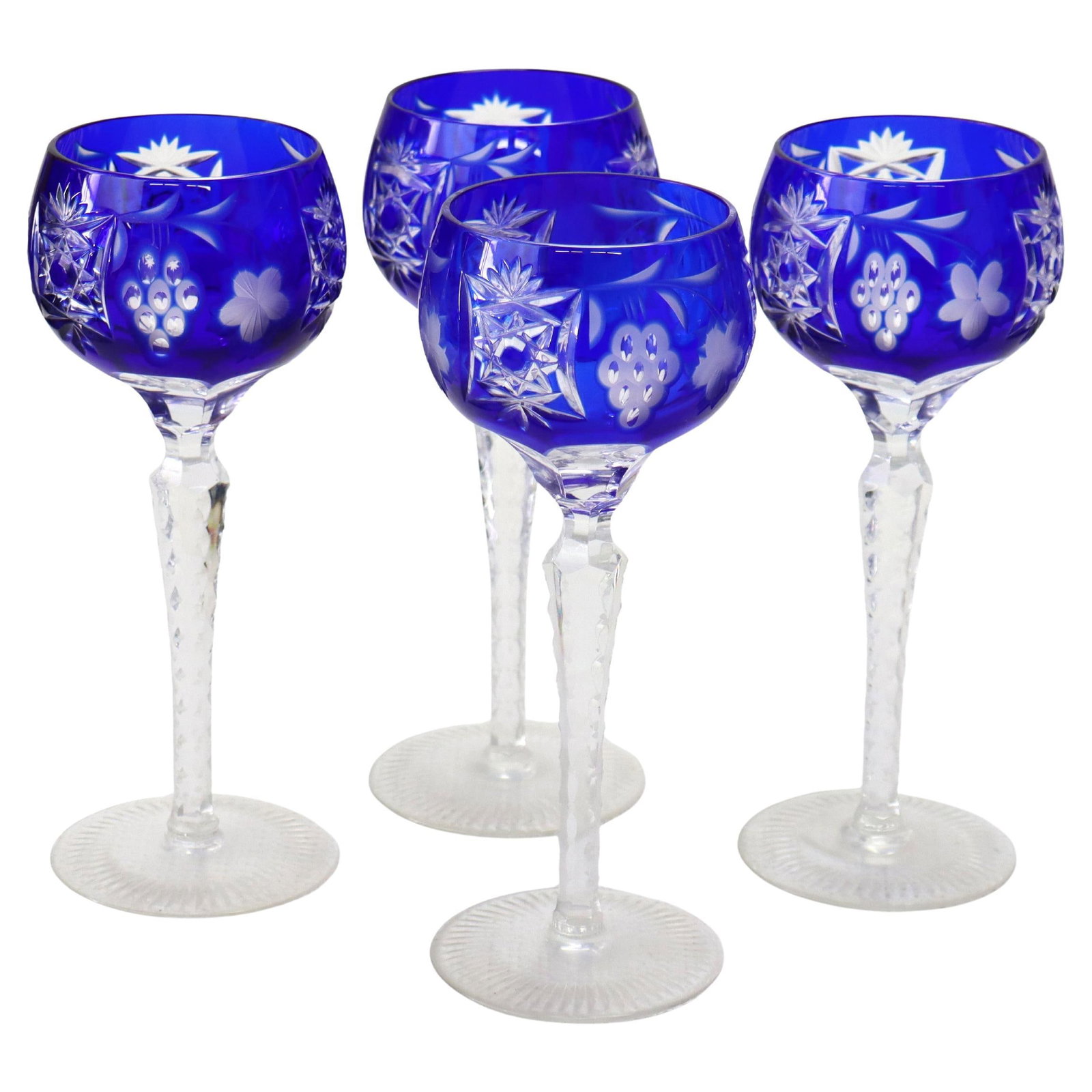 Set of 4 Bohemian Cobalt Blue Cut to Clear Wine Goblets with Floral Grape Motif: Set of 4 Bohemian Cobalt Blue Cut to Clear Wine Goblets with Floral Grape Motif This set includes four antique Bohemian cobalt blue wine goblets, each featuring intricate floral and grape motifs cut t