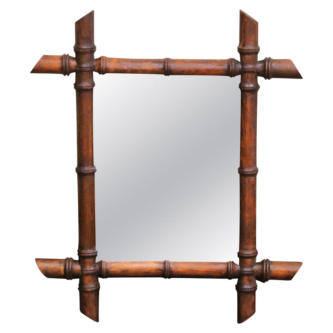 French Walnut Faux Bamboo Mercury Glass Mirror: French Walnut Faux Bamboo Mercury Glass Mirror This early 20th century French wall mirror features a hand-crafted walnut frame designed in a faux bamboo style, complete with stylized nodes and angled 