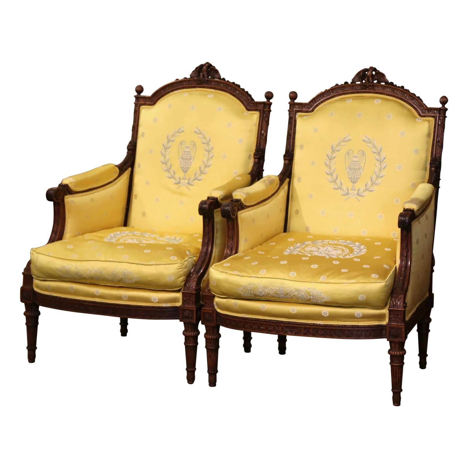 Set of 2 French Louis XVI Walnut Bergeres with Eagle Crest: Set of 2 French Louis XVI Walnut Bergeres with Eagle Crest This pair of late 19th century French Louis XVI bergeres features hand-carved walnut frames with striking eagle crest pediments. Each chair i