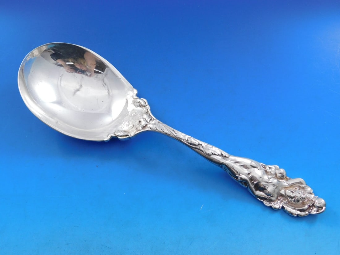 Reed & Barton Love Disarmed Sterling Silver Berry Spoon 10.5": Reed & Barton Love Disarmed Sterling Silver Berry Spoon 10.5" This exquisite serving spoon features the elegant Art Nouveau design of the 'Love Disarmed' pattern by Reed and Barton. Crafted from high-