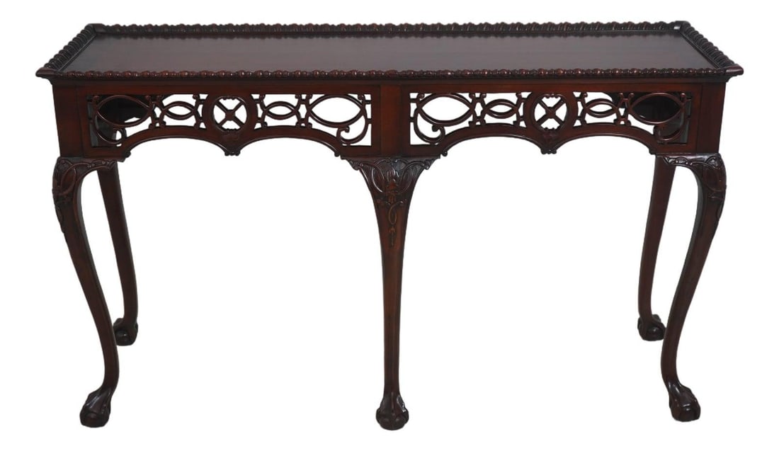 Chippendale Style Mahogany Console Table With Claw Feet and Carved Skirt: Chippendale Style Mahogany Console Table With Claw Feet and Carved Skirt This Chippendale style console table features a finely carved pierced skirt, ball and claw feet, and ornate carved legs. Crafte