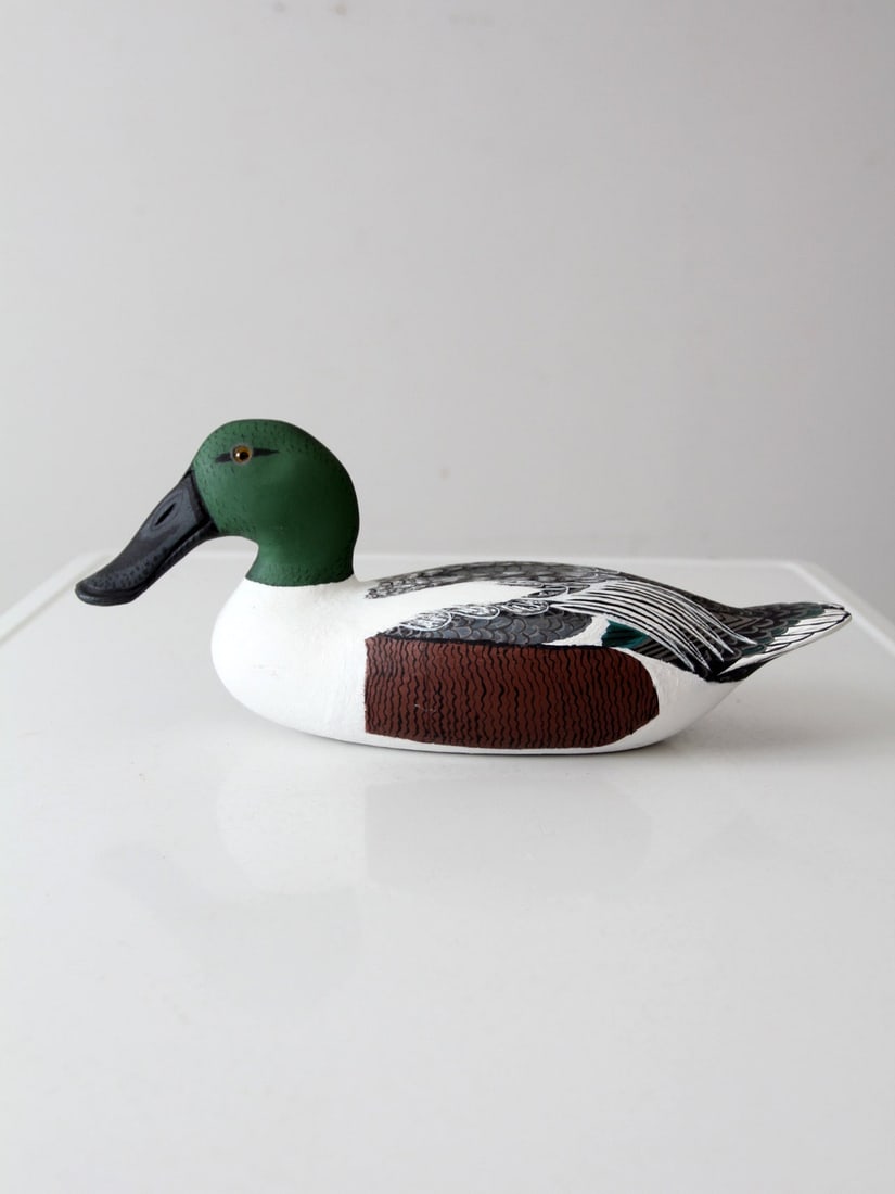 Signed 1993 Vintage Hand-Carved Drake Shoveler Decoy by Bill Reinsager: Signed 1993 Vintage Hand-Carved Drake Shoveler Decoy by Bill Reinsager This vintage hand-carved drake shoveler decoy, created by renowned carver Bill Reinsager in 1993, showcases the unique silhouette