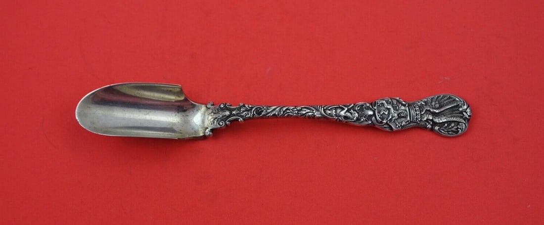 Durgin Heraldic Sterling Silver Cheese Scoop 8 1/4 Inch: Durgin Heraldic Sterling Silver Cheese Scoop 8 1/4 Inch Discover this exquisite large cheese scoop from the Heraldic pattern by Durgin, crafted from sterling silver. Measuring 8 1/4" in length, this p