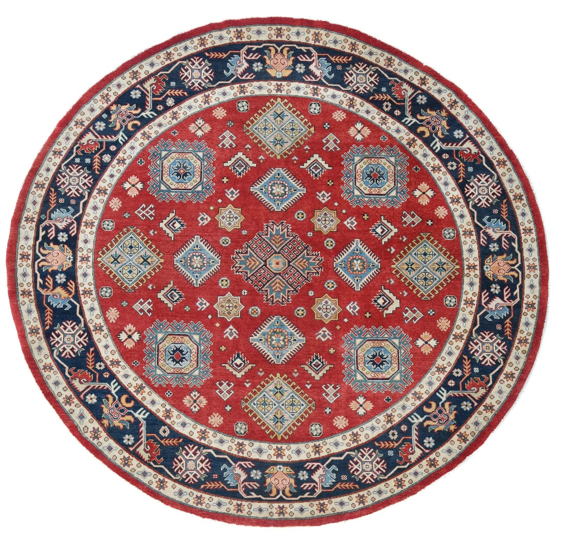 Handspun Wool Tribal Round Rug Kazak Design 9'0 x 8'10 ft: Handspun Wool Tribal Round Rug Kazak Design 9'0 x 8'10 ft Enhance your living space with this stunning Tribal Red Round Rug, beautifully handspun from high-quality wool. Featuring a vibrant combinatio