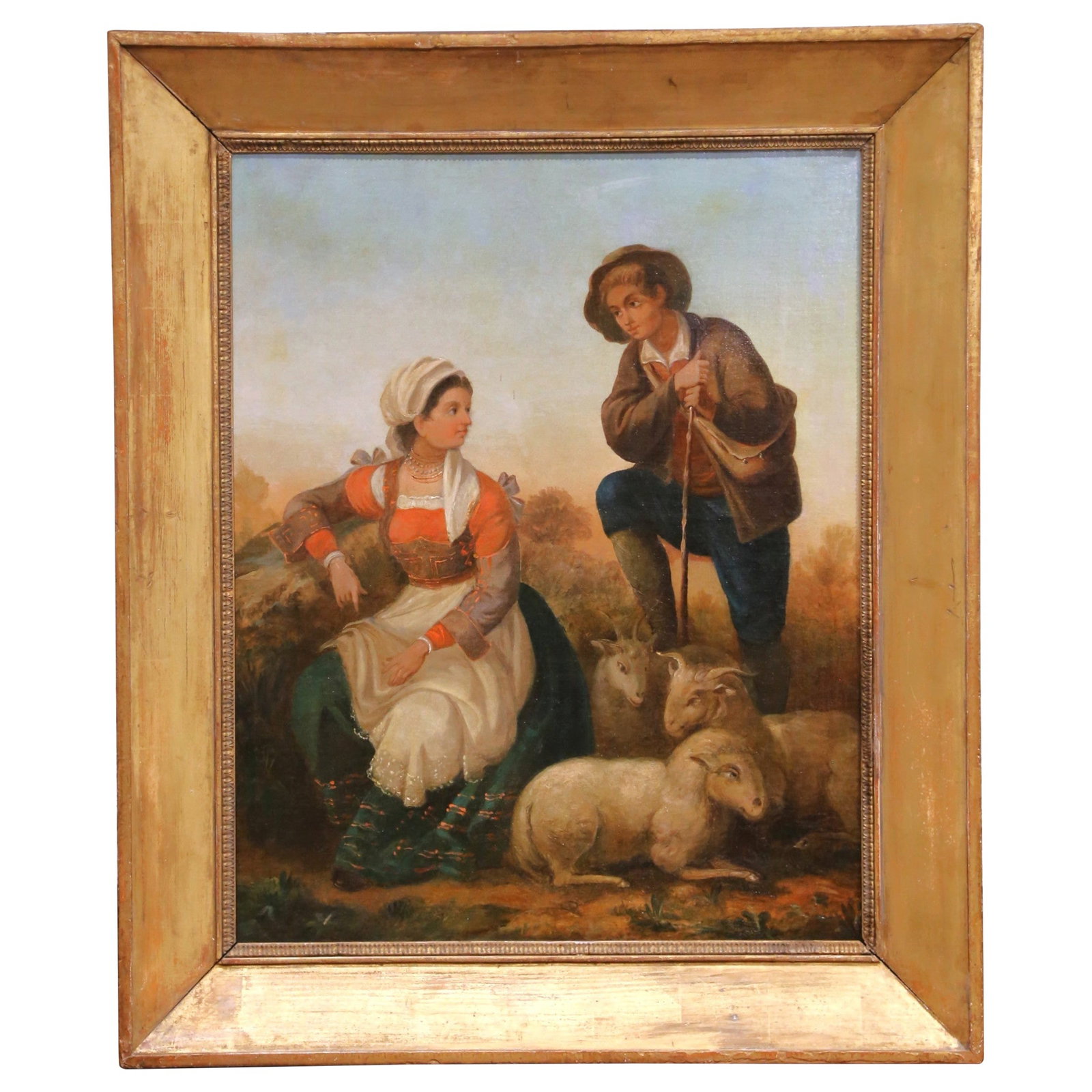 French Pastoral Oil Painting in Carved Giltwood Frame: French Pastoral Oil Painting in Carved Giltwood Frame This mid-19th century French oil on canvas painting, created circa 1860, beautifully captures a pastoral scene with a young shepherd and a seated 