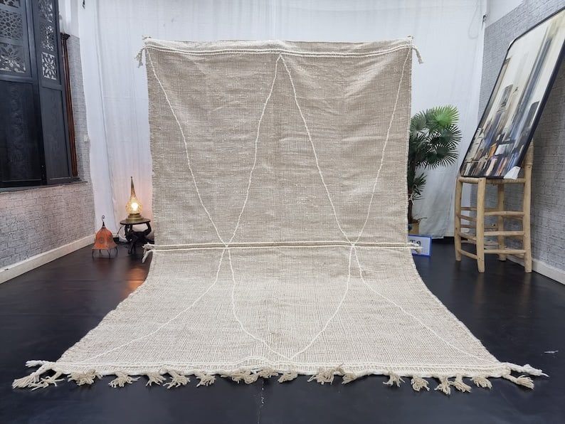 Handmade Moroccan Berber Wool Area Rug 9.84 x 6.56 Feet: Handmade Moroccan Berber Wool Area Rug 9.84 x 6.56 Feet Introducing a stunning handmade Moroccan Berber wool area rug, featuring an elegant white geometric pattern. This exquisite rug is handwoven in 