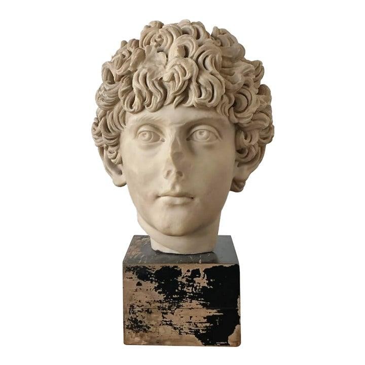 Cast Marble Marcus Aurelius Bust on Distressed Black Wooden Plinth: Cast Marble Marcus Aurelius Bust on Distressed Black Wooden Plinth This vintage bust depicts a youthful Marcus Aurelius, crafted in the Neoclassical revival style from high-quality cast marble. The sc