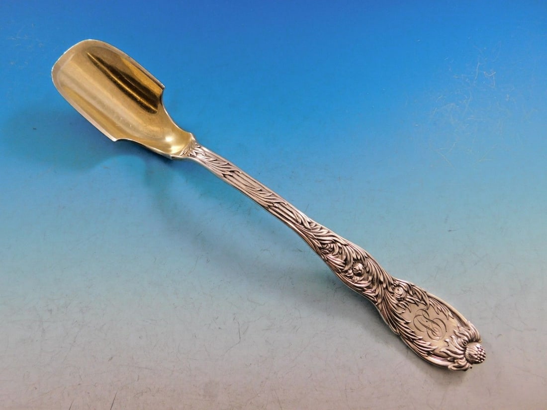Tiffany & Co. Sterling Silver Cheese Scoop Chrysanthemum Pattern Gold Wash 9 1/4 Inch: Tiffany & Co. Sterling Silver Cheese Scoop Chrysanthemum Pattern Gold Wash 9 1/4 Inch This is a pre-owned Tiffany & Co. Chrysanthemum sterling silver cheese scoop, designed circa 1880 by Charles Grosj