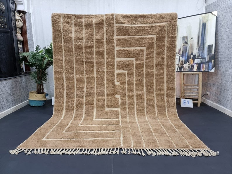 Authentic Moroccan Berber Wool Rug 9.84 x 6.56 Feet: Authentic Moroccan Berber Wool Rug 9.84 x 6.56 Feet This elegant, authentic soft brown handmade Moroccan Berber wool area rug features a striking geometric engraved pattern. Each rug is meticulously h