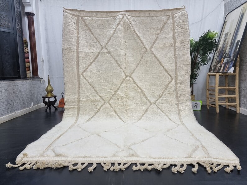 Authentic Moroccan White Wool Rug with Geometric Engraving 8 x 5 Feet: Authentic Moroccan White Wool Rug with Geometric Engraving 8 x 5 Feet This authentic white rug features a beautifully engraved geometric pattern, handwoven by local Berber women in the Atlas Mountains