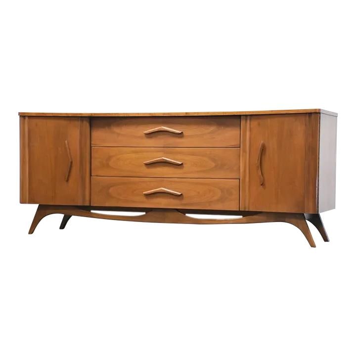 Mid Century Walnut Dresser with Sculpted Boomerang Pulls: Mid Century Walnut Dresser with Sculpted Boomerang Pulls This mid-century modern walnut dresser showcases a stunning design with sculpted boomerang pulls and a beautifully crafted walnut base. With am