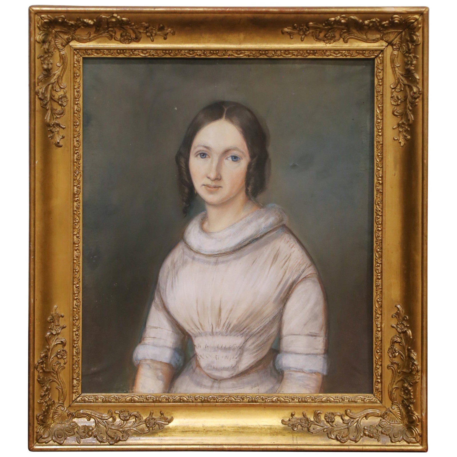 French Pastel Portrait of Young Woman circa 1850 in Ornate Giltwood Frame: French Pastel Portrait of Young Woman circa 1850 in Ornate Giltwood Frame This mid-19th century French pastel portrait depicts a young woman in a softly composed three-quarter pose, characterized by a
