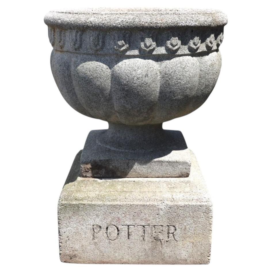 Cast Stone Melon Ribbed Garden Urn Potter c1900: Cast Stone Melon Ribbed Garden Urn Potter c1900 This antique garden urn, dating to circa 1900, features a classic melon-ribbed body with a detailed band of stylized floral or foliate motifs around the
