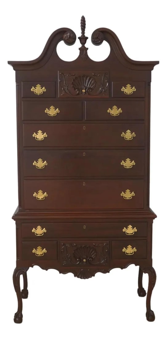 Mahogany Chippendale style highboy by Craftique: Mahogany Chippendale style highboy by Craftique This Chippendale style highboy is crafted from solid mahogany and features ball and claw feet, dovetailed drawer construction, and fine carved details. 