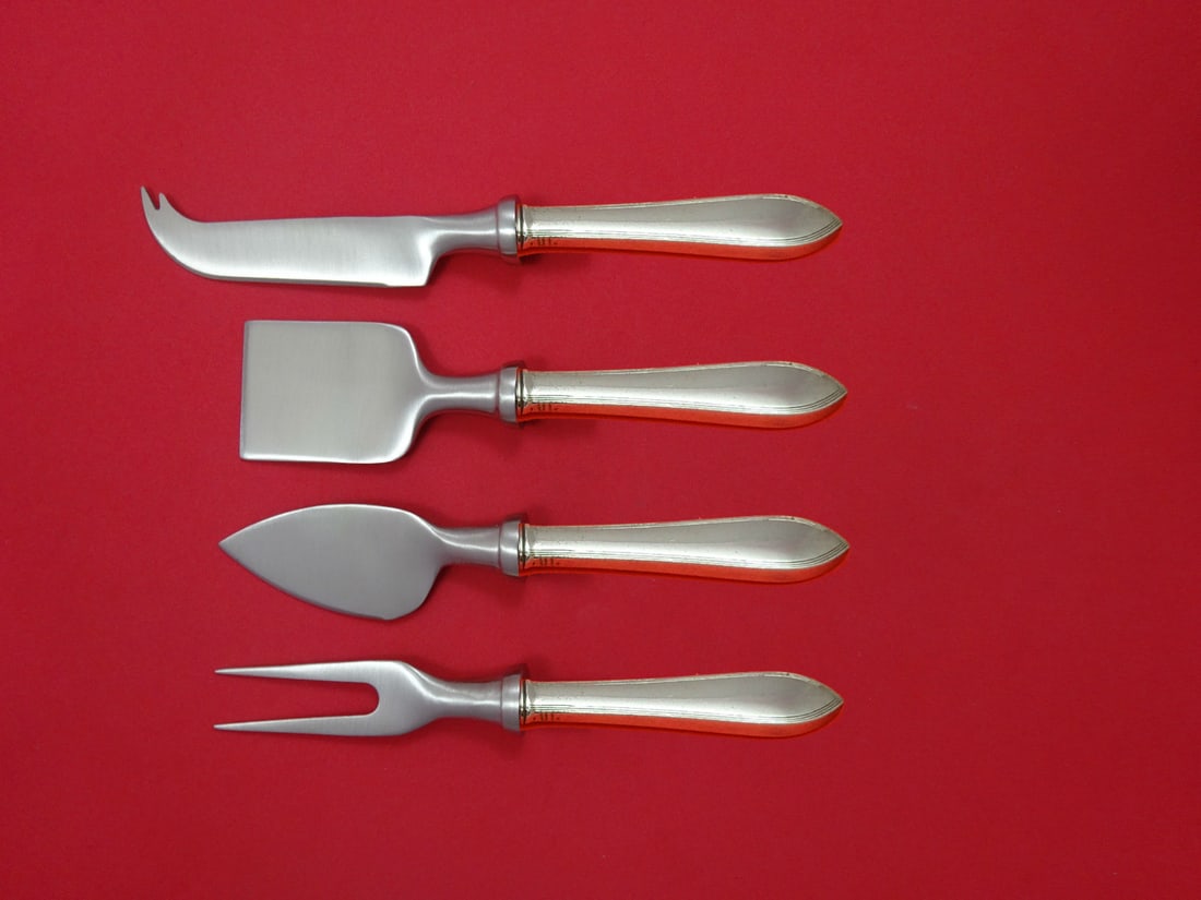 Tiffany & Co Reeded Edge Sterling Silver 4pc Cheese Serving Set: Tiffany & Co Reeded Edge Sterling Silver 4pc Cheese Serving Set Elevate your entertaining with this exquisite 4-piece cheese serving set from Tiffany & Co. Crafted in the elegant Reeded Edge pattern, 
