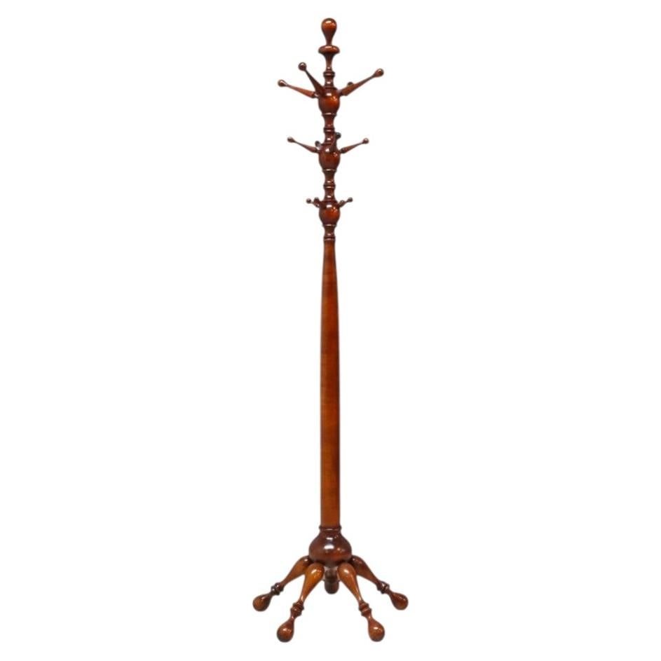 Mahogany Hall Tree with Stick and Ball Details: Mahogany Hall Tree with Stick and Ball Details This antique mahogany stick and ball coat rack dates to around 1920 and showcases early 20th-century craftsmanship. The hall tree features a finely turne